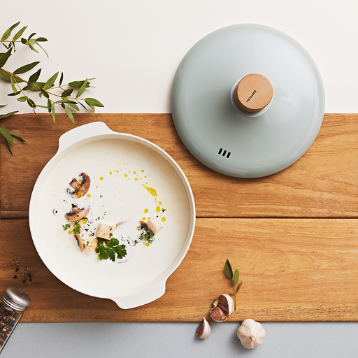 The 24cm Happycall Zium ceramic nonstick induction pot in a sage green finish, shown with its matching lid, light wood knob, and dual side handles.