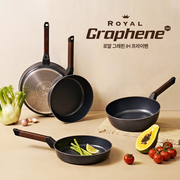 Happycall Royal Graphene wok on a kitchen counter with fresh papaya and tomatoes.