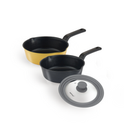 The 3-piece Happycall Flex nonstick saucepan set, showing the 22cm yellow saucepan, the 20cm black saucepan, and the grey VIVA silicone multi-lid.
