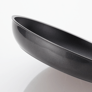 Side View of Happycall Plasma Titanium Frypan: A close-up side view of the Happycall Plasma Titanium Frypan, focusing on the sleek, slightly curved edge and the smooth, nonstick exterior.

