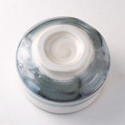 Base of Harukasumi matcha bowl showing hand-glazed foot ring and kiln marks.

