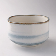 Japanese matcha bowl with soft blue haze glaze and hand-formed rim.

