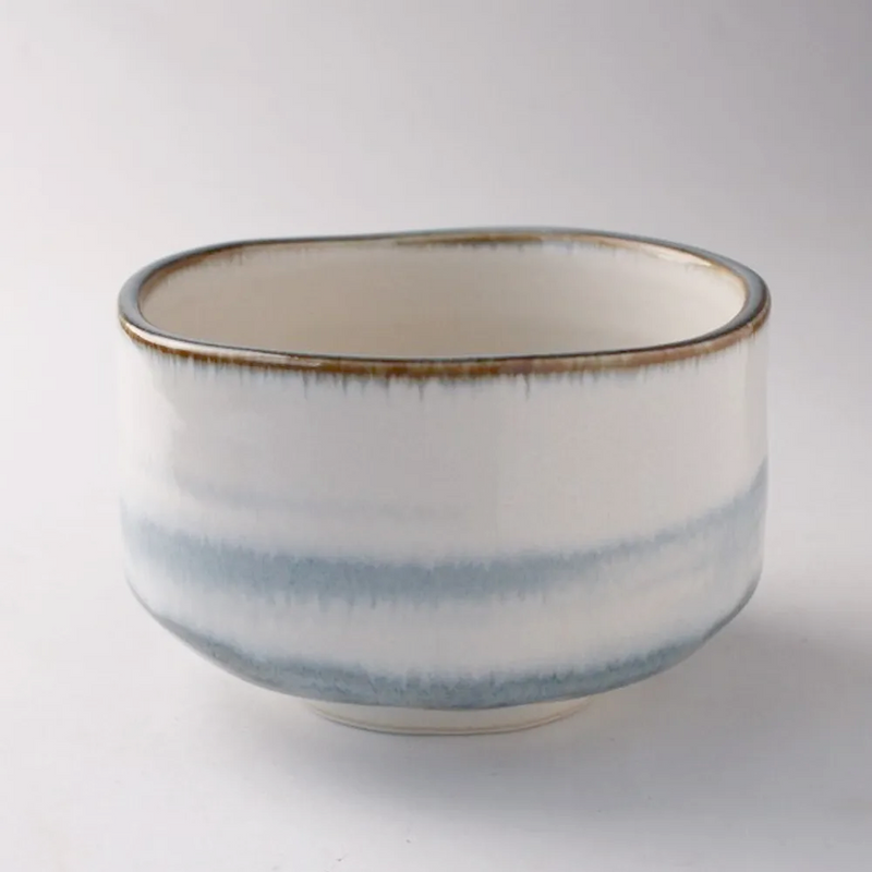 Japanese matcha bowl with soft blue haze glaze and hand-formed rim.

