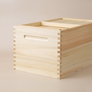 The Hinoki Cypress Wooden Rice Storage Box (5kg), highlighting its natural wood grain, traditional finger-joint construction, and recessed handle.
