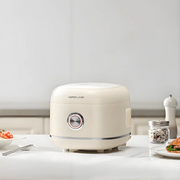 Modern kitchen scene with Hoper Layer stainless steel rice cooker preparing multiple dishes for a family meal.
