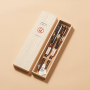 The Ishida Grand Fireworks Wakasa Nuri Chopstick Set, showing two pairs of lacquered chopsticks with red and black designs in an elegant Kiri wood gift box.