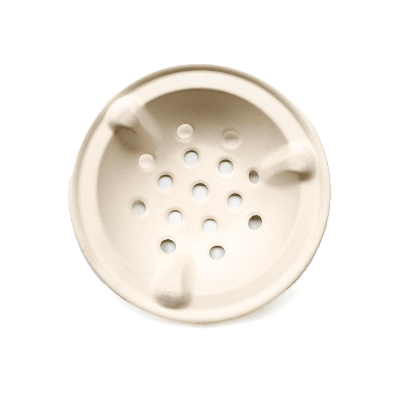 A beige diatom mud trivet with multiple holes, intended as a replacement part for a Japanese grill.