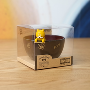 The Ishida Shiba Inu soup bowl and chopstick rest set, shown in its clear retail packaging on a wooden table.