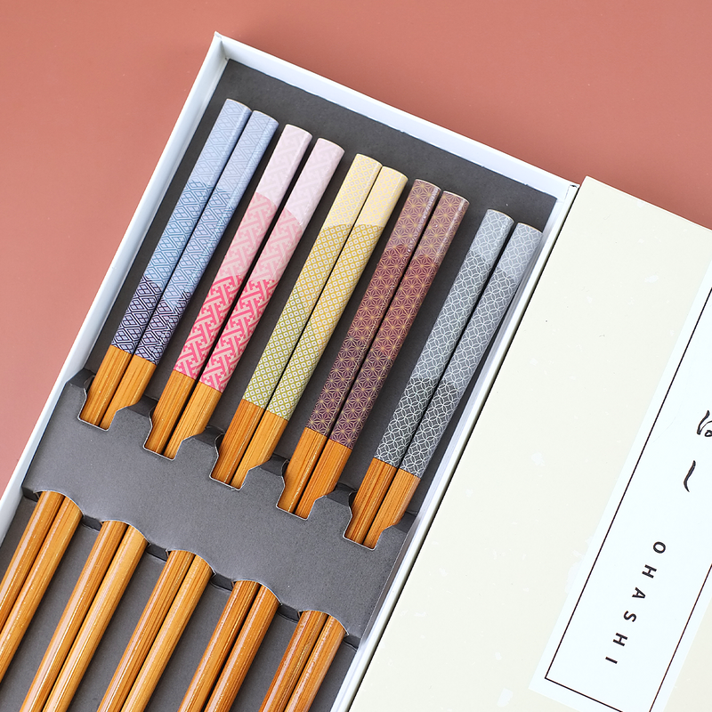 Ishida Weather Delight Chopstick Set featuring five pairs of chopsticks in light blue, pink, yellow, brown, and grey, each uniquely patterned, showcased in a vertically oriented package, Made in Japan