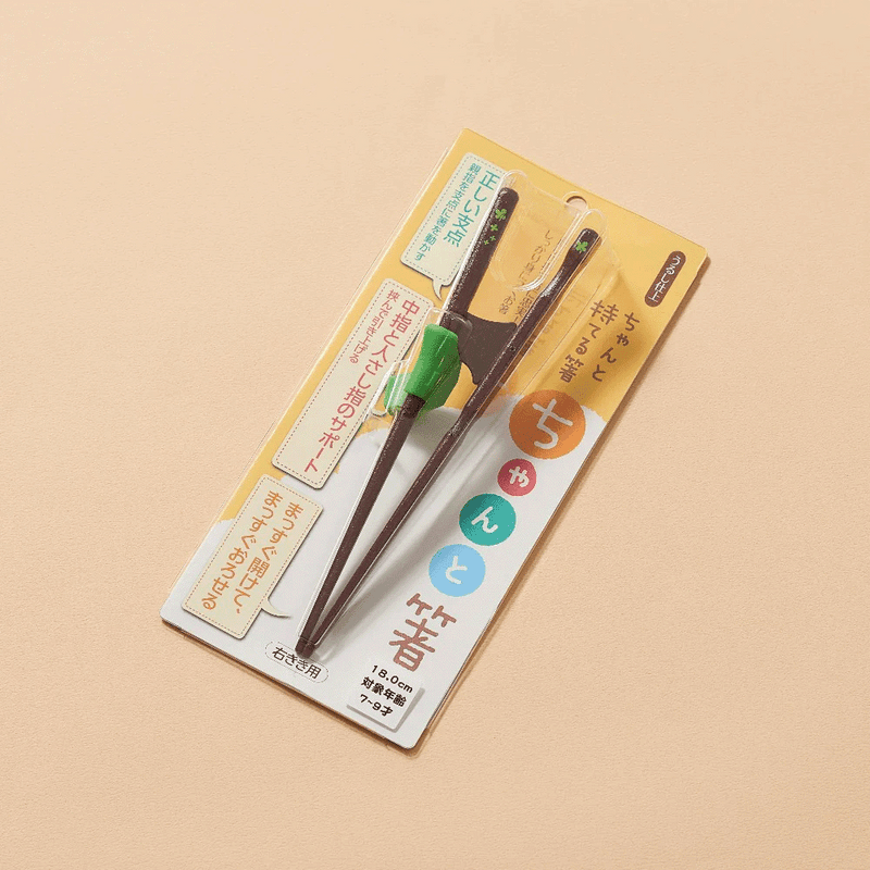 A pair of Ishida wooden training chopsticks for right-handed children (18cm), showing the ergonomic shape and supportive silicone finger guide.