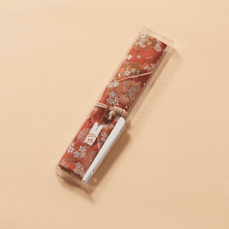 The Kyoto Nishijin Chopstick Pouch, showing the intricate "Spring Flower Basket" woven pattern on a fabric background.