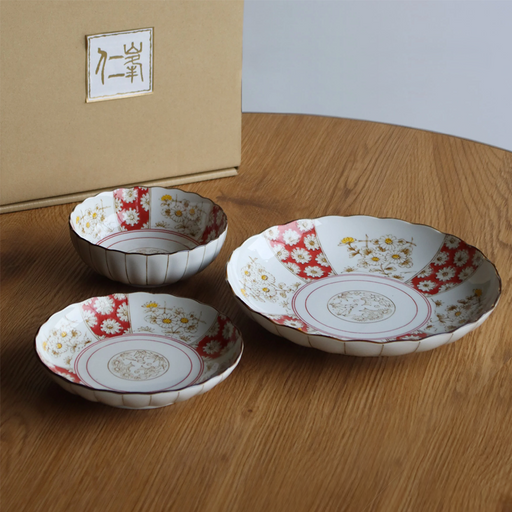 A 3-piece Japonica Kikka dinnerware set featuring a large plate, medium plate, and small bowl, decorated with a traditional red and white chrysanthemum pattern and scalloped edges.