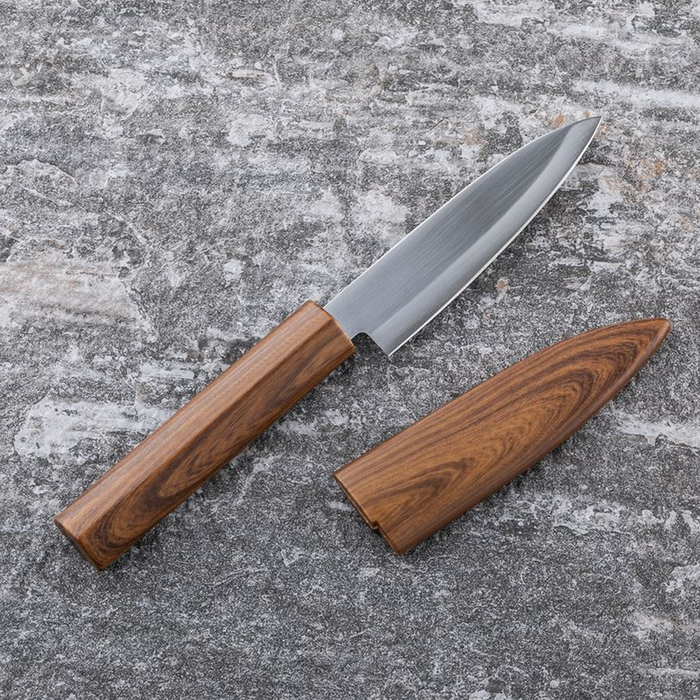 Close-up of Kai Kitchen fruit knife blade with logo engraved on stainless steel and wooden handle.