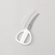 The Kai Seki Magoroku Curved Kitchen Scissors and their matching white protective blade cover, shown together on a plain background.
