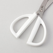 A close-up of the large, ergonomic white handles of the Kai Seki Magoroku kitchen scissors, designed for a comfortable grip.
