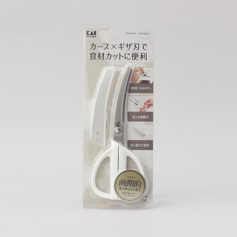 A close-up of the large, ergonomic white handles of the Kai Seki Magoroku kitchen scissors, designed for a comfortable grip.
