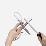 A demonstration of the Kai ceramic rod's versatility, being used to sharpen the blades of a pair of kitchen scissors.
