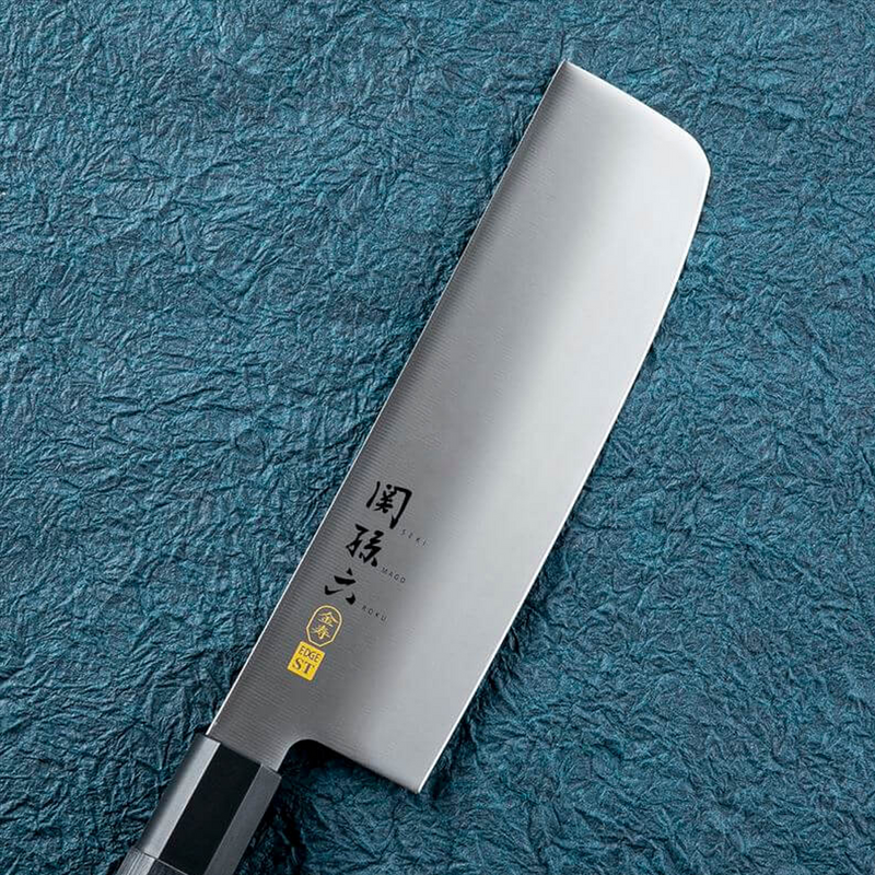 A detailed close-up of the traditional hexagonal composite wood handle on the Kai Seki Magoroku Nakiri knife.
