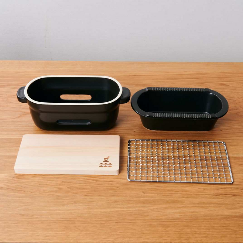 The disassembled Kamoshika Douguten konro grill showing its four components: the outer body, inner charcoal holder, wire mesh, and wooden base.

