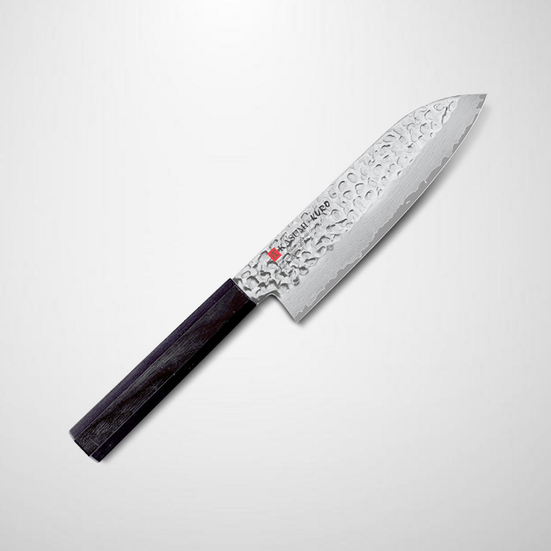 The Kasumi Kuro hammered Damascus Japanese Santoku knife, 170mm, showing its textured blade and dark octagonal handle, angled against a light grey background.
