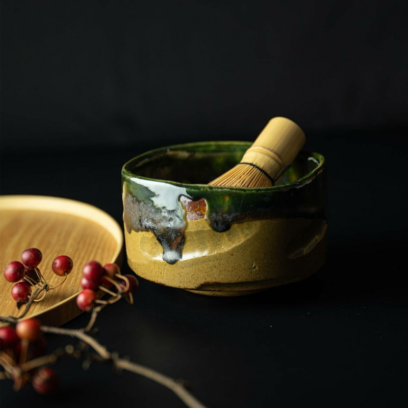 Side view of the Kochidori Matcha Bowl, showcasing the rich contrast between the deep green glaze and natural clay body.






