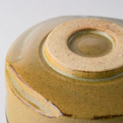 Close-up of the textured base of the Kochidori Matcha Bowl, showing natural clay details and unglazed finish.
