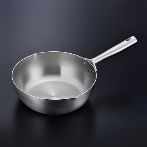 Kogu 3-ply stainless steel wok 24cm with a hollow handle and pouring spouts on a dark background.