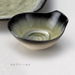 Detail-oriented close-up of a Kunkiln Donabe bowl, highlighting its characteristic texture and emerald design.