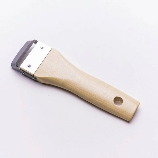 A detailed close-up of the Kyoto Katsugu Forged Peeler, showing the sharp high-carbon steel blade and traditional wooden handle.