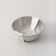 The LaLa Shine bowl and strainer set nested for compact storage, shown with its retail packaging.

