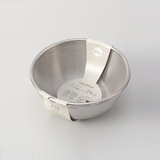 The LaLa Shine bowl and strainer set nested for compact storage, shown with its retail packaging.


