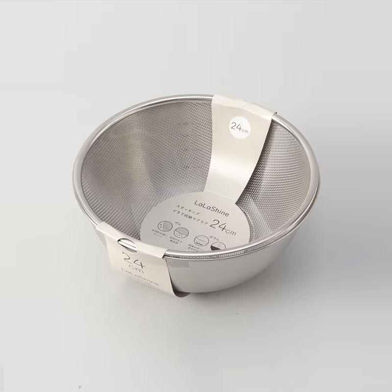 The LaLa Shine bowl and strainer set nested for compact storage, shown with its retail packaging.

