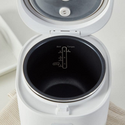 Interior view of the LocknLock Macaron Mini Rice Cooker showing the non-stick pot with capacity markings for rice and congee.