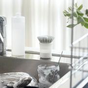 Marna Antibacterial Detergent Dispenser Brush standing by the sink - A Marna dispenser brush placed upright on a kitchen sink, ready for use.
