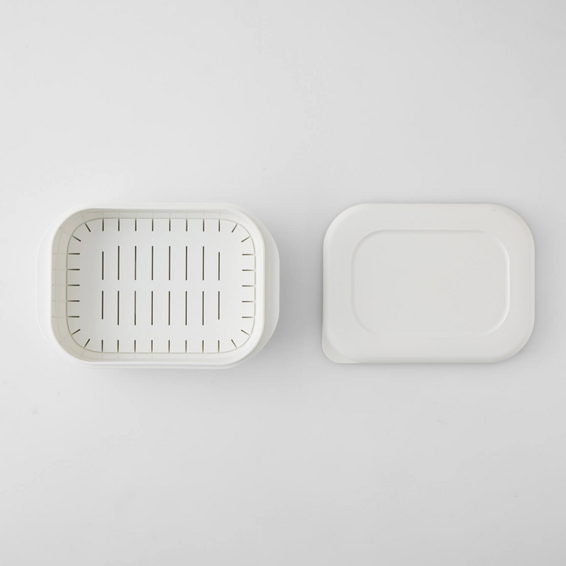 Top-down view of the Marna Kiwami Freeze & Microwave Rice Container, open to show the slatted insert inside the base and the lid placed alongside it on a white background.