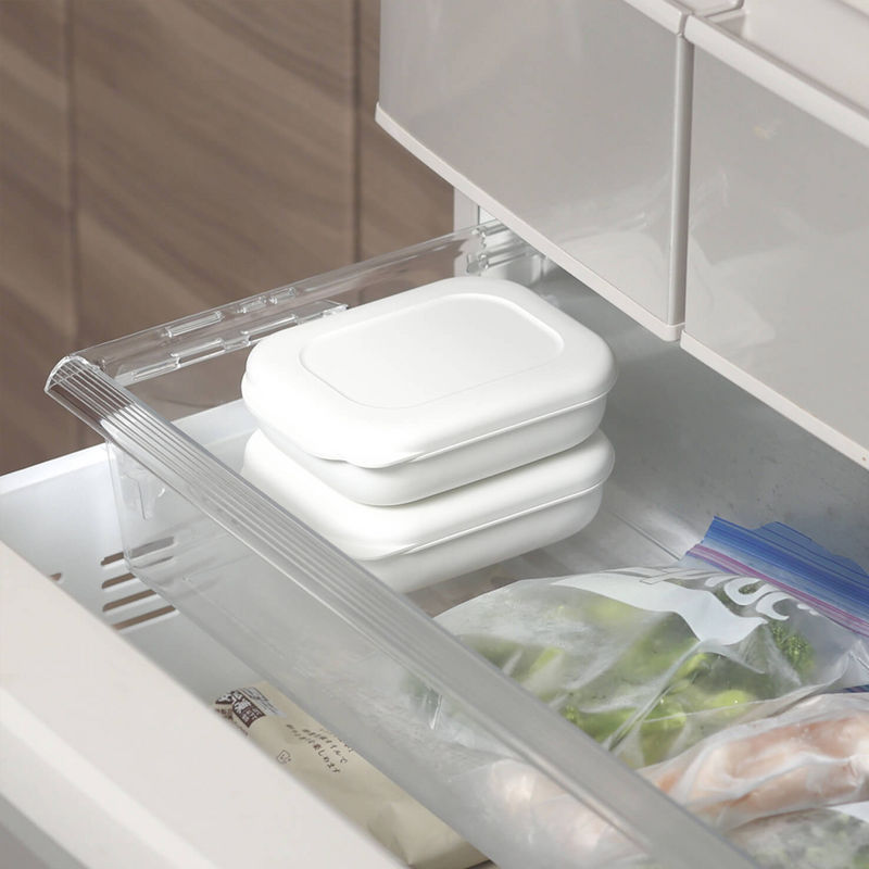 Two stacked Marna Kiwami Freeze & Microwave Rice Containers stored neatly inside a freezer drawer.