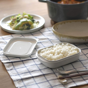 The Marna Kiwami Freeze & Microwave Rice Container filled with cooked rice, displayed as part of a meal setting on a checked tablecloth.