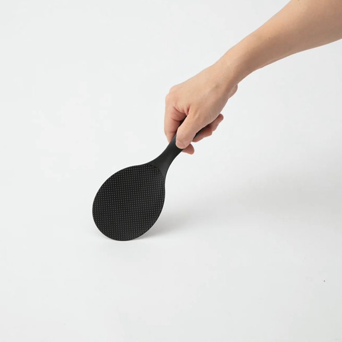 Marna Premium Standing Rice Scoop in black held by hand, showing ergonomic handle and textured paddle

