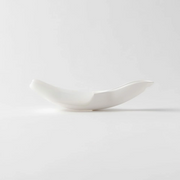 A side profile view of the Marna rice washer, showing the ergonomic curve of its design.