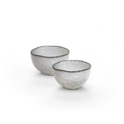 A studio shot of the Midnight Elegance Kohiki Sake Cup set of two, showing their asymmetrical shape and smoky grey glaze with a dark rustic rim.