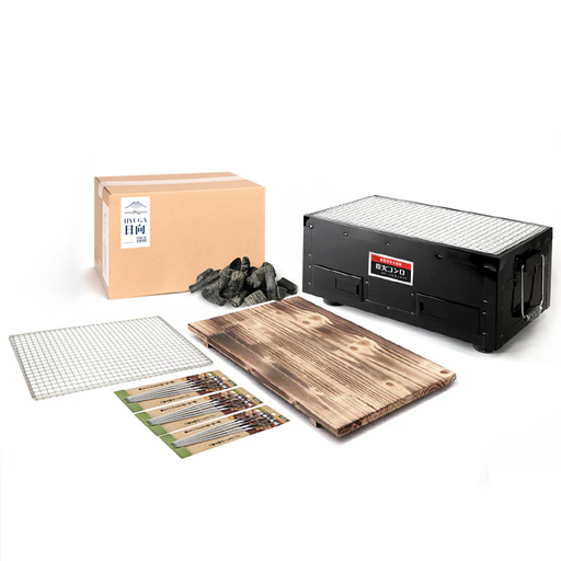 Mikawa Konro Grill Starter Set featuring a 38cm black rectangular hibachi grill, wooden base, stainless steel skewers, and 2kg of Miyazaki Hyuga Binchotan charcoal.