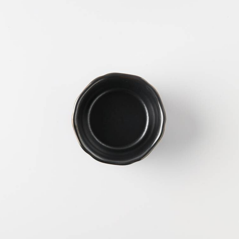 Close-up view of a grey ceramic bowl with a black interior and a distinct gold rim, emphasizing the elegant curvature and design.