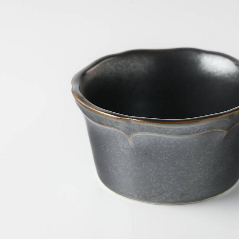 Top view of a grey ceramic mini bowl with a deep black interior, highlighting the round shape and smooth surface.