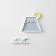 A Mino Yaki tableware set featuring a light blue Mount Fuji sauce plate, a yellow moon chopstick rest, and two wave chopstick rests in white and light blue.