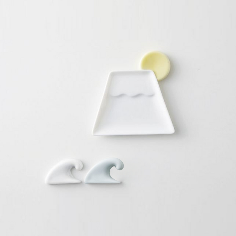 A Mino Yaki tableware set featuring a white Mount Fuji sauce plate, a yellow moon chopstick rest, and two wave chopstick rests in white and light blue.