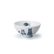 A side view of the Mino Yaki Neko Maru Cat Bowl, showing its footed base and the blue illustration of cats and a fish on a white porcelain background.