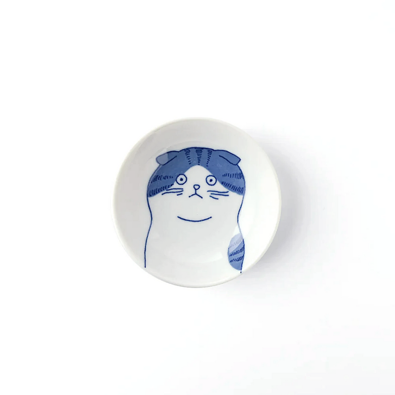 A studio photo of the Shichita Mino Yaki Cat Scottish Side Bowl, showing the blue and white illustration of a Scottish Fold cat's face from a top-down perspective.