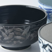 Side profile of the Mitsuhide Akechi Kikyo Bowl featuring subtle, raised Kikyo flower and leaf motifs in dark ink glaze.