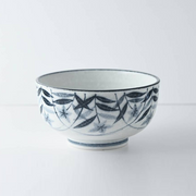 Side view of the bowl, highlighting the intricate floral pattern with delicate leaves and blossoms in gentle relief.