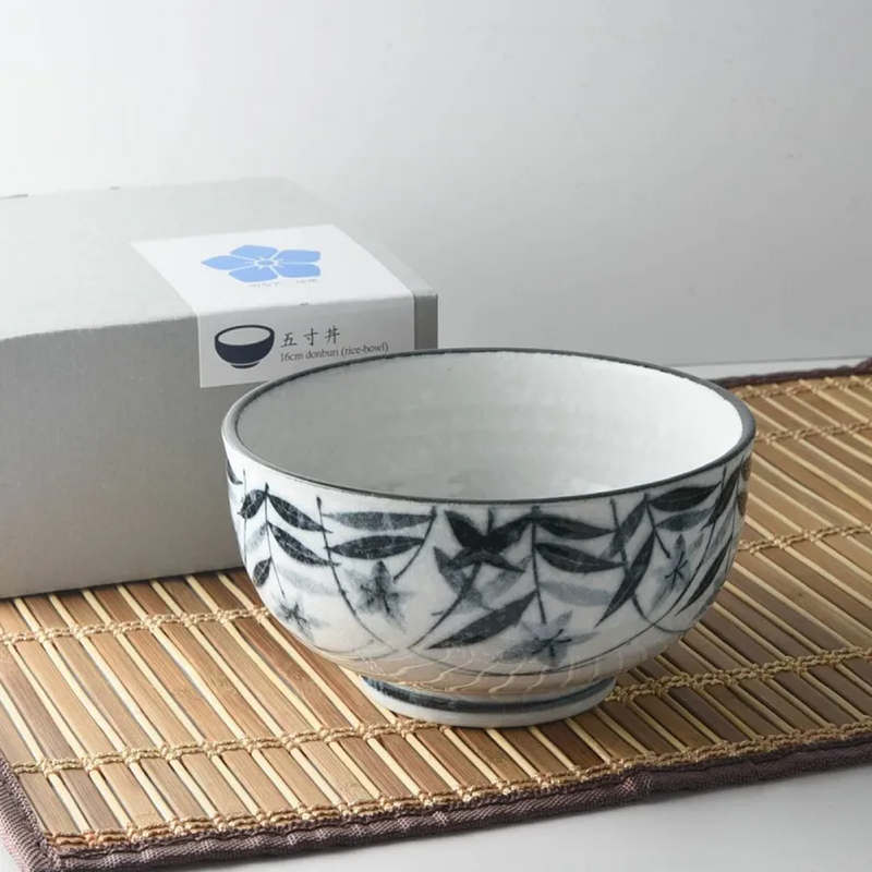 A ceramic bowl with a deep, glossy dark ink finish and a raised Kikyo (bellflower) motif encircling the exterior.